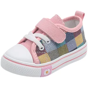 Colorful plaid patchwork kids canvas shoes with pink velcro strap and daisy detail.