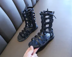 Close-up of black children's high-top gladiator sandals with side zipper and lace-up detail