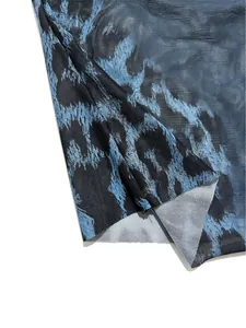 Close-up of stylish blue and black leopard print mesh fabric showing its intricate textile texture.
