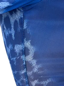 Close-up of blue leopard print mesh fabric showing high-quality stitching and texture.