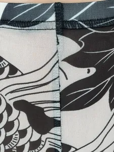 Close-up detail showing the mesh fabric texture and black and white botanical print