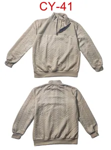 Detail view showing the cable knit texture and quarter-zip collar of the beige sweatshirt