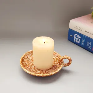 Gros plan d'un bougeoir moderne en céramique avec glaçure mouchetée et bougie
