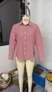 Detail of a red and white gingham long-sleeved button-down shirt on a mannequin.