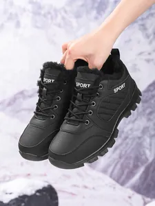 Hand-held black women's high-top winter snow boots with warm fleece lining and thick sole
