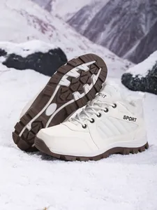 Close-up of white waterproof snow boots with warm faux fur lining and anti-slip sole