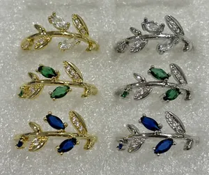 Detailed view of branch-shaped rings in gold and silver with colorful marquise stones