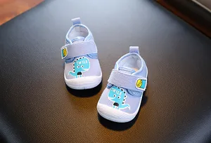 Vue détaillée de chaussures de marche bébé bleu clair avec motif dinosaure