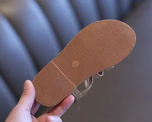Detailed macro view of non-slip rubber sole for girls' Roman sandals showing size markings