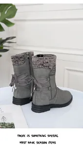 Detailed view of grey winter ankle boots featuring knitted cuffs and ribbon lace-up back