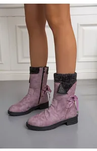 Close-up of purple winter boots with knitted cuffs and ribbon bow detail
