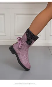 Detail shot of purple winter boots with grey knit collar and pink bow accent