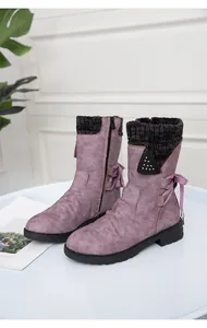 Side detail of purple mid-calf boots featuring a knit collar and lace-up bow design