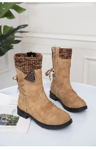 Detailed view of tan winter boots with a knitted collar texture and side zipper feature