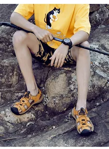 Detail of durable closed-toe men's leather sandals for outdoor hiking on rocks
