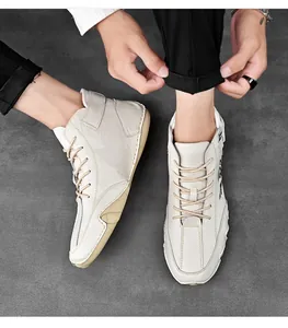 Top view of men's beige leather high-top casual shoes with handmade stitching details.
