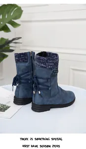 Side view of blue mid-calf winter boots with knitted collar and back laces