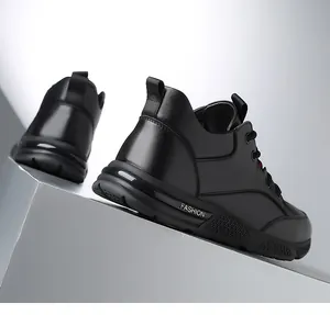 Detail view of the textured black leather upper and durable rubber sole of men's casual shoes.
