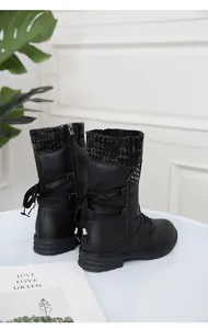 Detailed view of black winter ankle boots featuring a knit cuff and rear decorative lacing