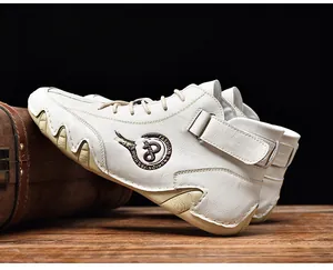 Close-up of white leather mid-top men's shoes featuring a unique wavy rubber sole