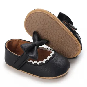 Bottom view and front angle of black baby walking shoes with bow detail