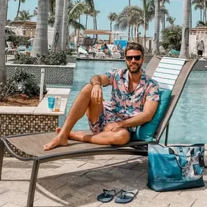 Men's summer beach two-piece set with pink leaf print on a resort background