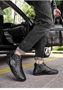 Detail of black leather mid-top men's shoes while stepping out of a black vehicle