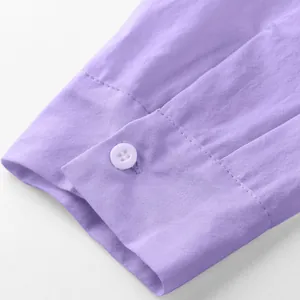Detailed close-up of a light purple men's long sleeve shirt cuff with a white button