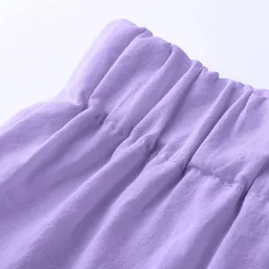 Macro view of elastic waistband and fabric texture on men's purple cotton shorts