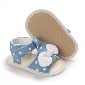 Detailansicht der blauen Polka-Dot-Babysandalen mit weicher rutschfester Sohle und Schleife