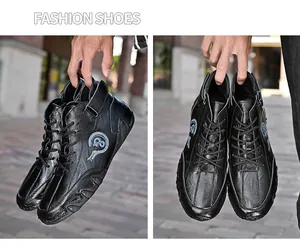 Close-up detail of black leather mid-top casual men's driving shoes with side logo.