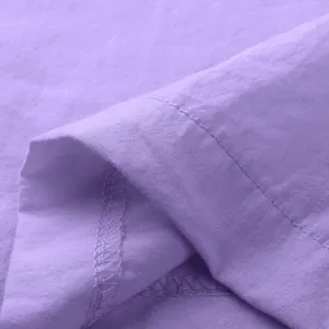 Close-up of purple fabric detail and stitching for men's casual shirt and shorts set