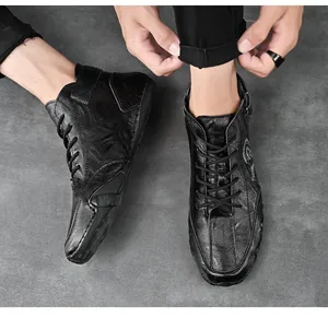 Close-up detail of men's black leather high-top casual shoes with retro handmade stitching