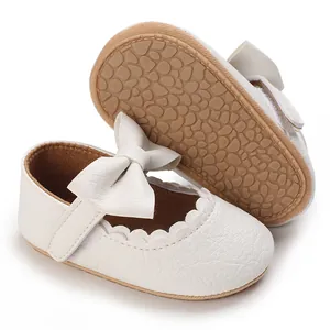 Detailed view of white baby Mary Jane walking shoes with elegant bow and soft anti-slip sole