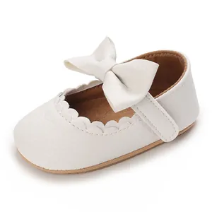 Close-up detail of a white baby princess walking shoe featuring a soft sole and a large bow.