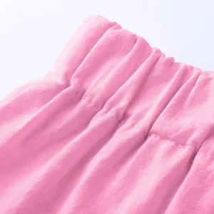 Close-up view of a pink elastic waistband with detailed stitching on soft cotton fabric.