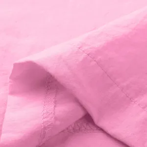 Close-up of pink fabric texture and stitching detail for men's solid color set.