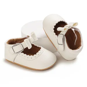 Close-up of white baby girl walking shoes with bow detail and soft sole