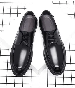 Top view of classic black leather men's business dress shoes on a geometric background