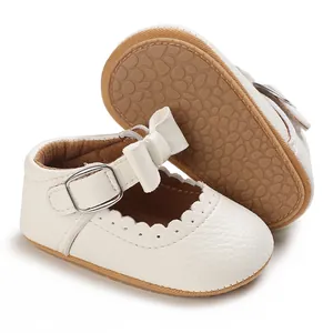 Classic white Mary Jane baby walking shoes featuring soft non-slip rubber soles and bow details
