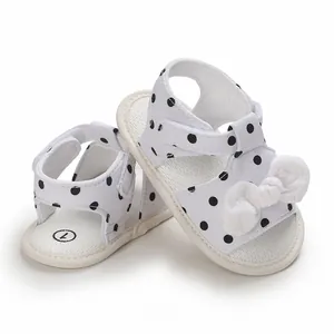Breathable white baby sandals with black polka dots and elegant lace bow, soft pre-walker shoes