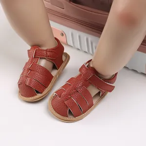 Detail of reddish-brown baby fisherman sandals with soft soles and velcro straps