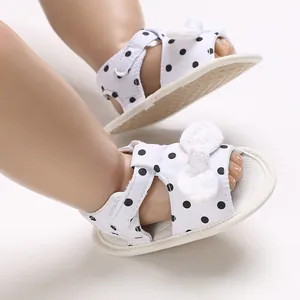 Infant breathable white sandals with black polka dots and a cute decorative bow