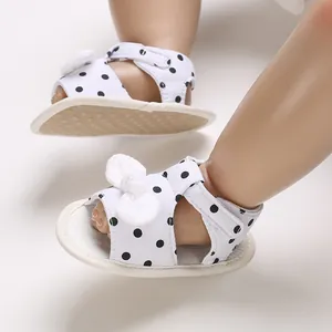 Soft sole baby girl polka dot sandals with white bow detail and anti-slip bottom