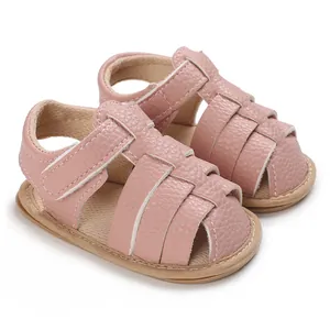 Soft sole pink baby sandals for summer with textured leather straps and hook loop closure.