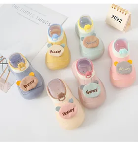 Detailed view of colorful baby cartoon sock shoes with soft anti-slip soles for newborn toddlers