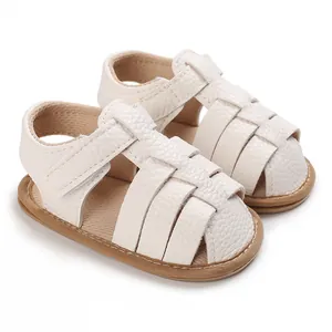 Macro view of white soft-sole summer baby sandals featuring textured faux leather