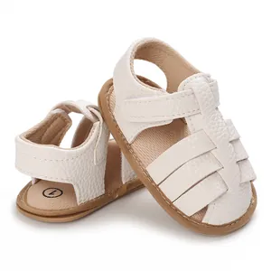 Close-up of white soft sole baby sandals with lychee grain texture