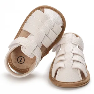 Detailed close-up showing white woven leather texture on these soft sole baby sandals