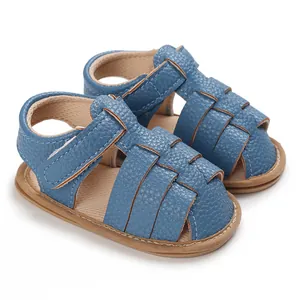 Detailed view of blue lychee-textured soft leather baby sandals with woven straps